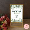 Napis 'COCKTAIL kotiček' v elegantnem zlatem okvirju. Izposoja tablic z napisi.