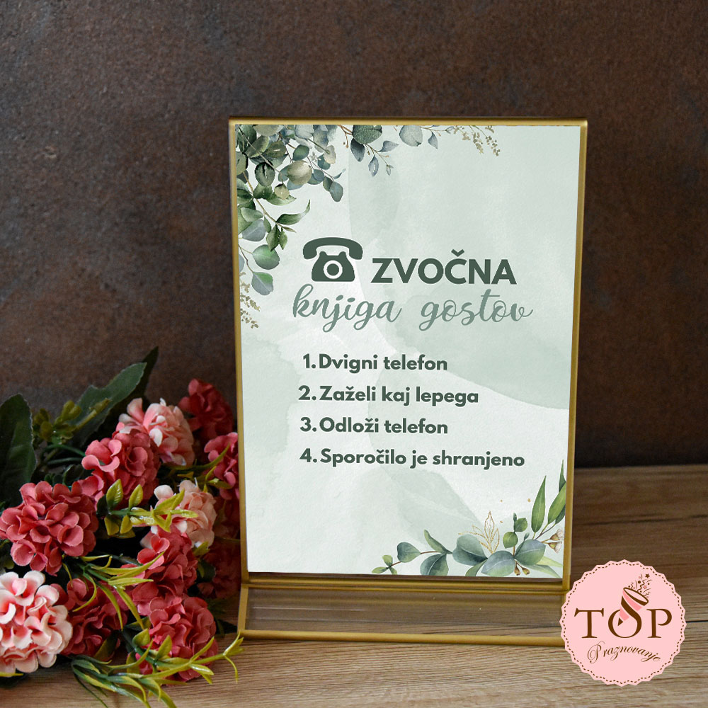 Izposoja tablice z napisom zvočna knjiga gostov v zlatem okvirju z zelenjem.